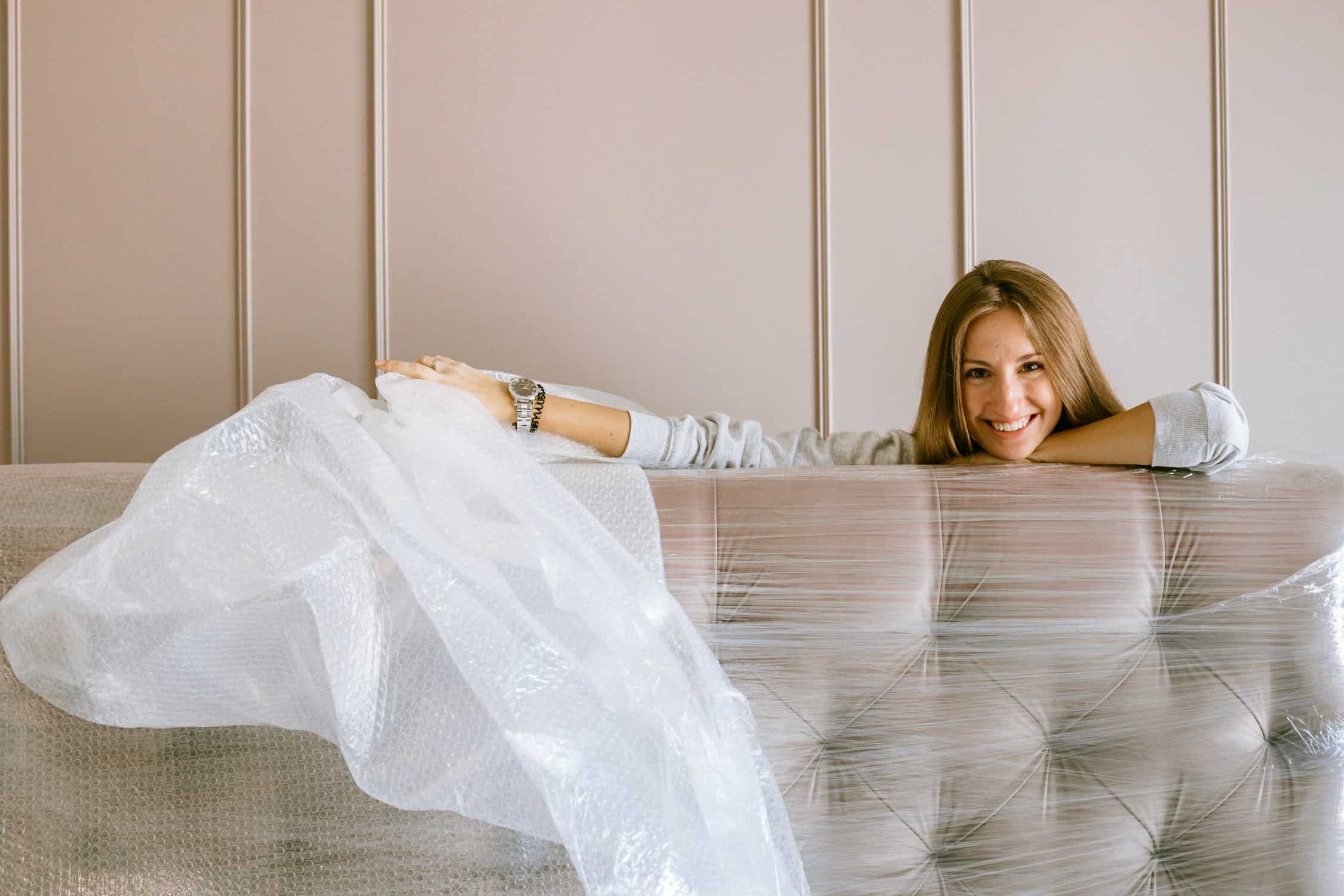 Woman wrapping a mattress