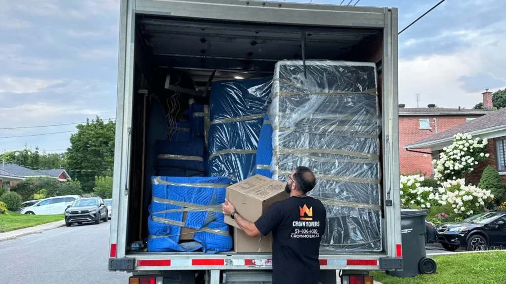 crown mover putting a box in the back of the moving truck where the items are perfectly packed