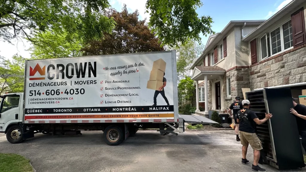 Professional moving team from Crown Movers efficiently handling property management relocation tasks, showcasing organized packing and expert furniture handling